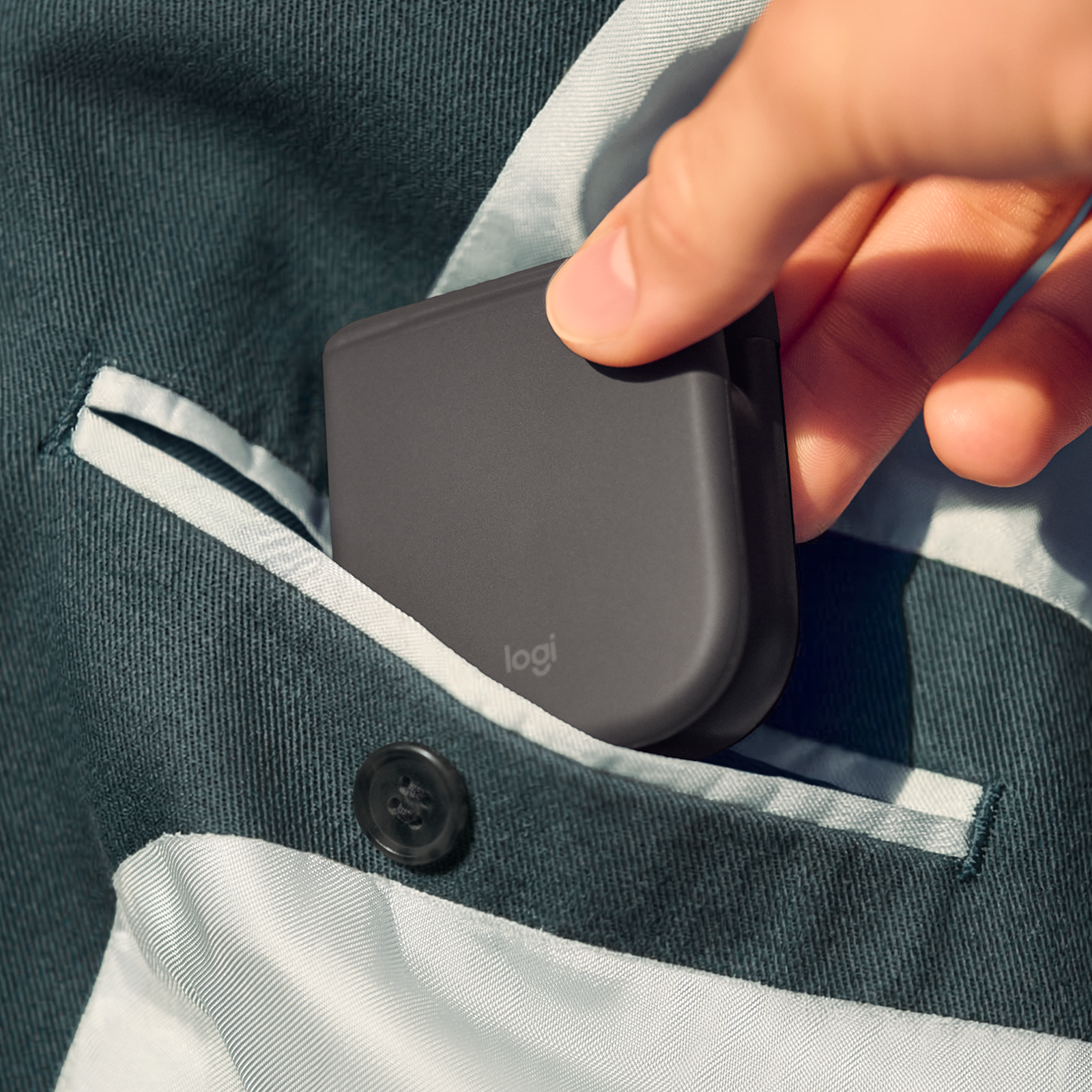 Logitech Mobi Fold mouse Graphite folded and slipping into a pocket